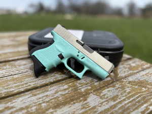 PRE-OWNED GLOCK 26 9MM LIGHT BLUE/SILVER SEMI AUTO HANDGUN